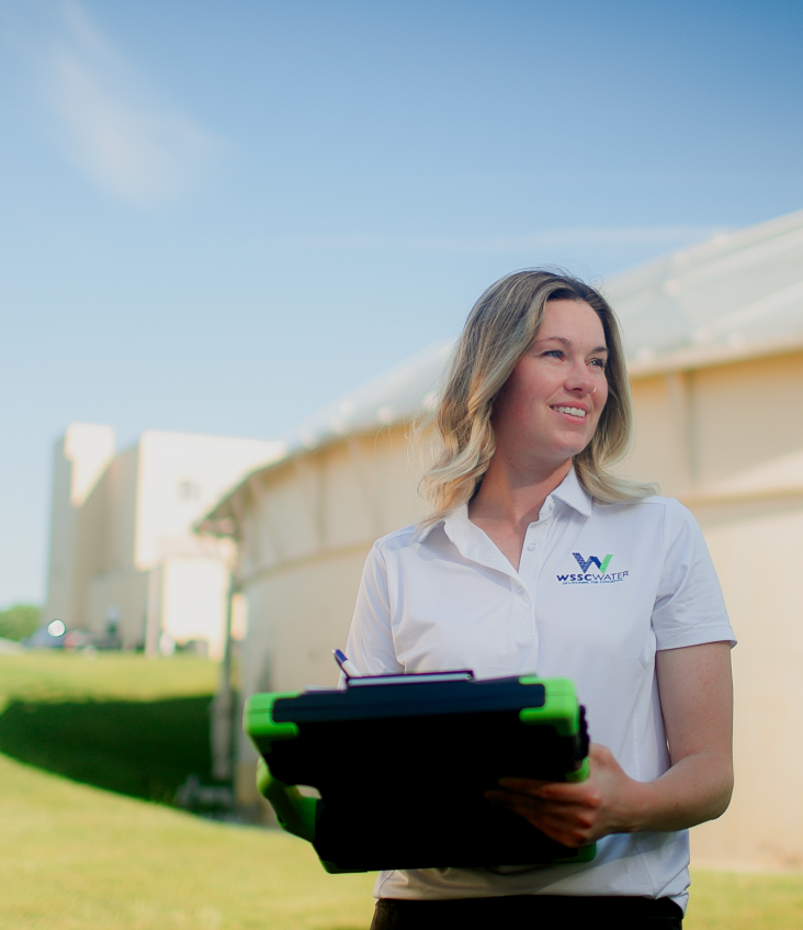 Gabriella Lafayette on an industrial discharge site with clipboard
