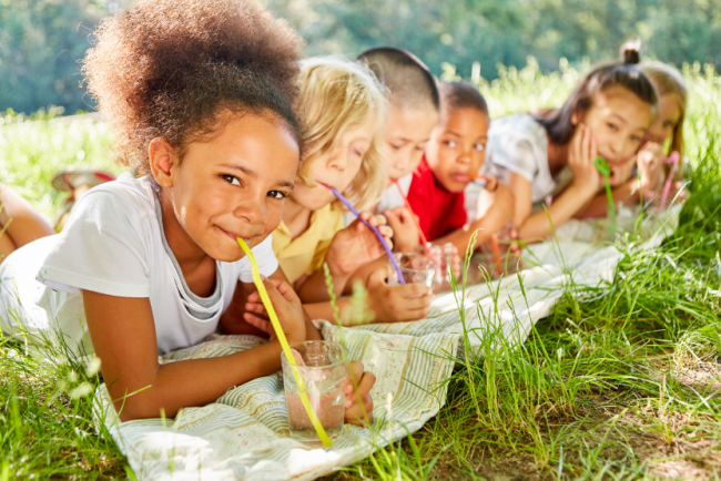 Children drinking tap water outside 