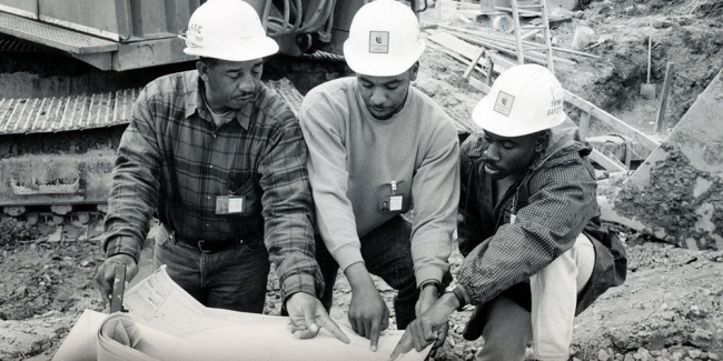 history book - workers looking at plans