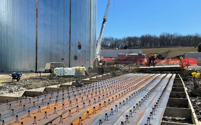 The metal strips being prepared on the right will fill in the joints (gaps) that you see on the digester walls on the left.