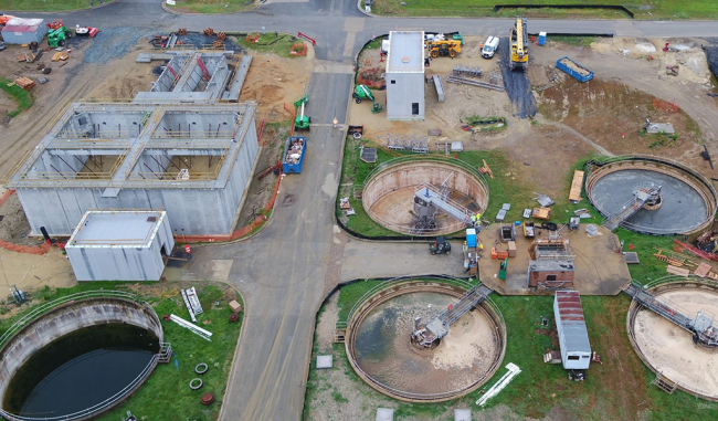 On the left is a better shot of the Sidestream Treatment Facility with the new walls in place.  The rectangular building across the road is the Sidestream Chemical Storage Building with its new roof.  Below the Chemical Building is a better look at the new clarifier mechanical equipment.