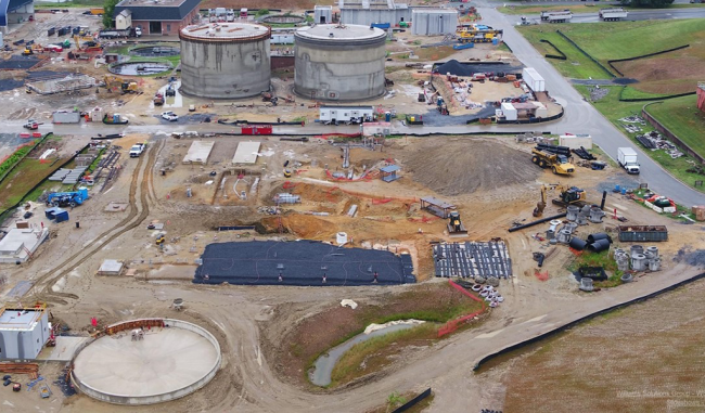 This is the western side of the site.  At the bottom of the photo is the slab for the Gas Storage Facility with the concrete walls going up on the perimeter.  To the left of it is the Blower Building.