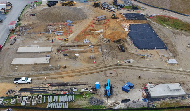 The two rectangular concrete pads on the left of this photo will support the Boilers.  The excavation to the right of the pads is preparation work for the Generators.  The fresh concrete slab at the bottom right is the foundation pad for the Gas Flare Facility, which will be used to burn off excess gas that is not converted to electricity.