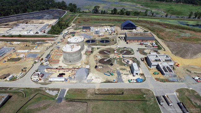 The Anaerobic Digesters, the two tall, round, concrete tanks in the middle of this picture are being prepared for their final coating.  To the left slabs are prepped for the Digester Control Building.  