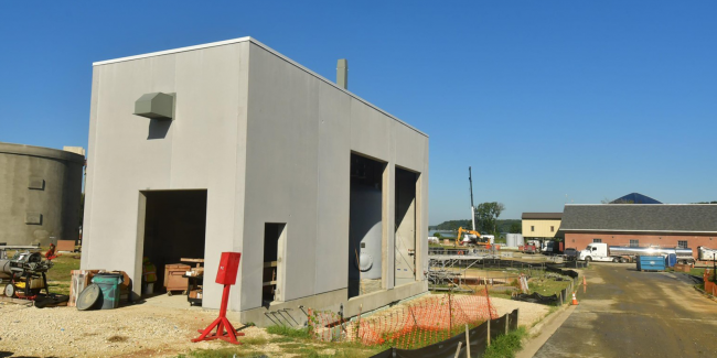 This is the Chemical Building for the Sidestream Treatment Process.  The mechanical work is being done inside.  Through the door openings on the right side you can see the chemical storage tank in place.