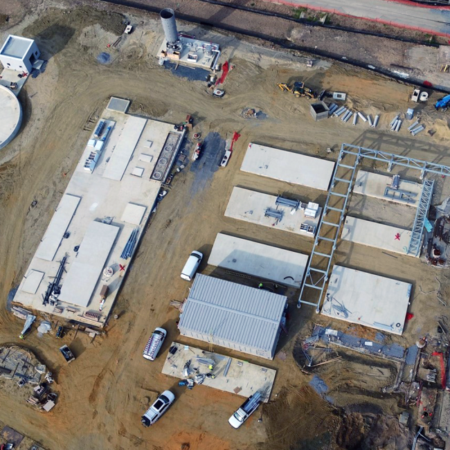 Aerial view of the Combined Heat & Power project area.  Concrete pads are in place for the boilers and generators.  The structure at the bottom center of the photo is the new Power Distribution Center (PDC) for this area.