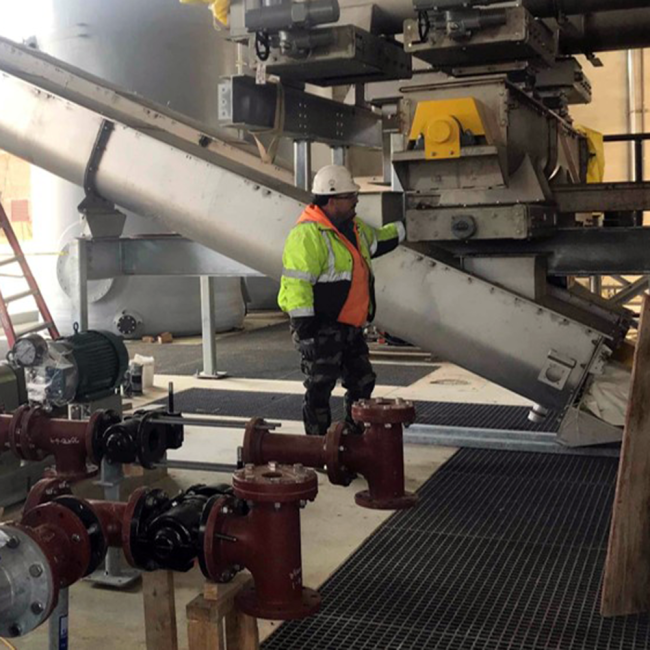 This photo is taken inside the Solids Building.  This is part of the conveyor system that will move the biosolids from the Solids Building to the Storage Facility.