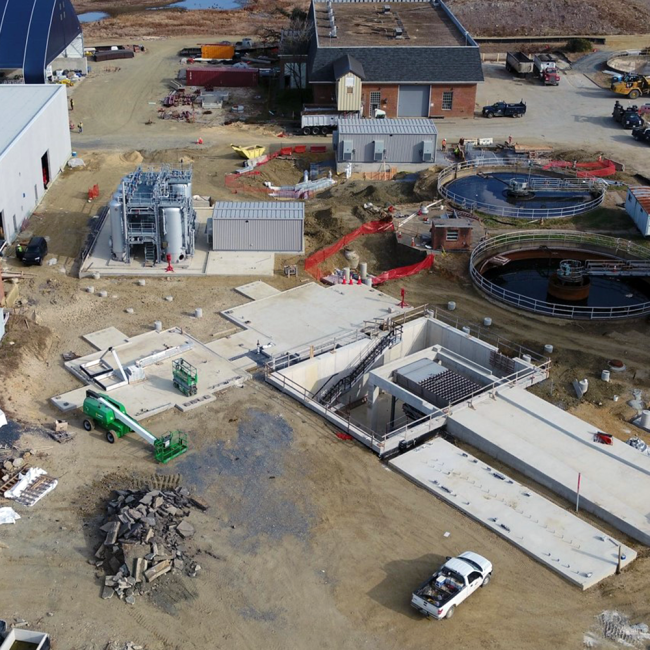 A closer view of the Cake Receiving Facility with the hopper in place.  Also you can see the truck approach slab, or driveway, is nearing completion.