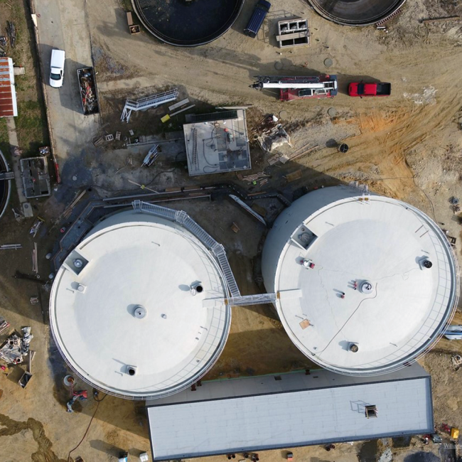 Overhead view of the Anaerobic Digesters and the Cake Receiving Facility.  At the bottom of the Digesters you can see work ongoing for the overflow trench.