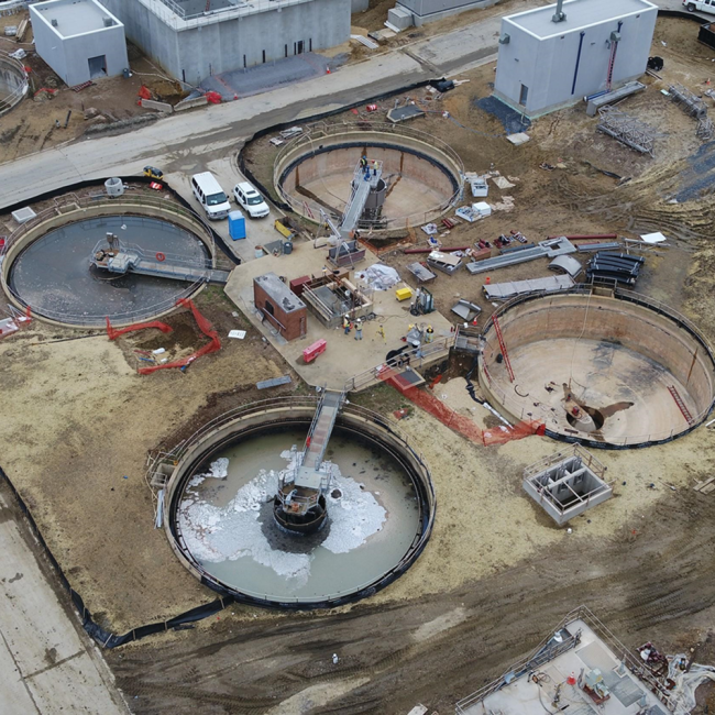 This aerial view shows the rehabilitation of the gravity thickeners.  The top one has the new mechanical equipment already in place.  The one on the right has had all the old equipment removed.