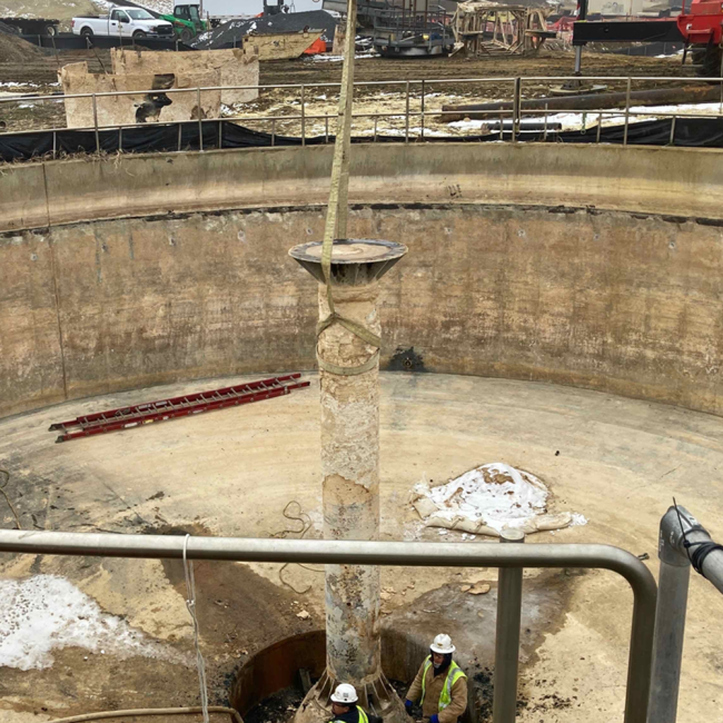 Workers here are removing the center column structure from one of the gravity thickeners.