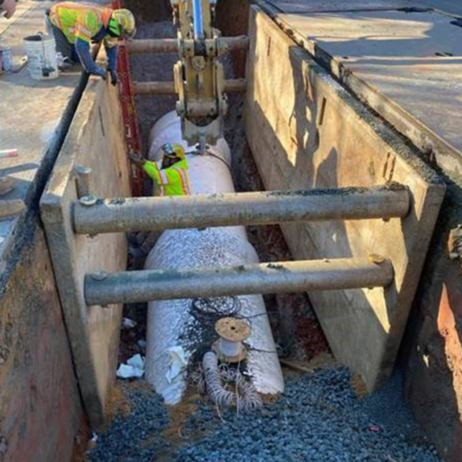placing and honing a 20 foot piece of the new 48” Raw Water Line on Bondmill Road