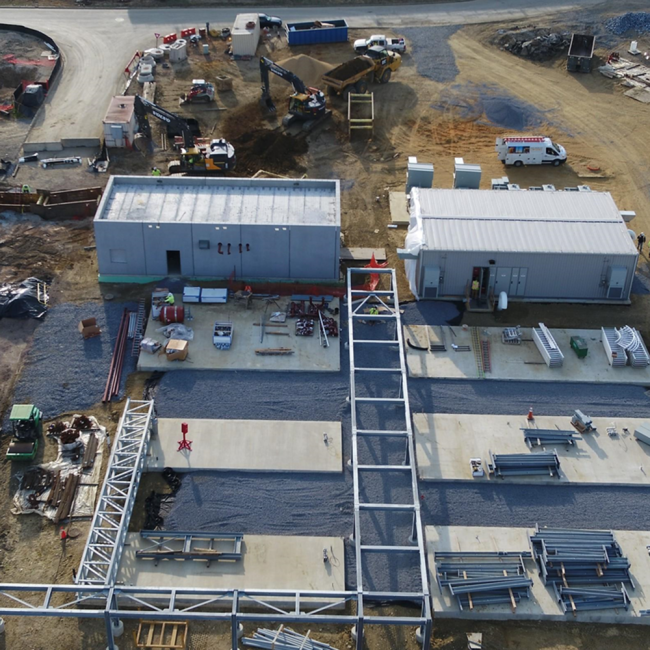 Here in the Combined Heat & Power (CHP) area of the project site, this photo shows crushed stone being placed between the boiler pads and the generator pads.  