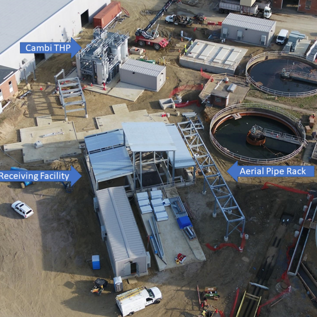 Aerial view of the Cake Receiving Facility.  The roof decking is going on the metal framework.  To the right is a section of aerial pipe rack.