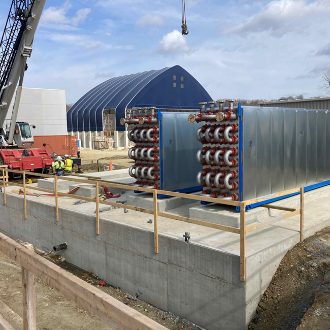 This photo shows the installation of two of the Heat Exchanger (HEX) units.  