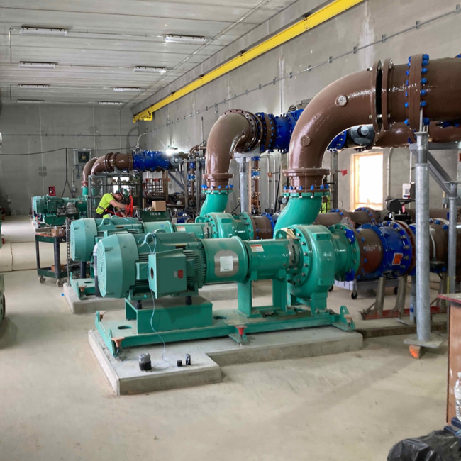 This photo shows the pumps, process piping and mechanical work inside the Digester Control Building