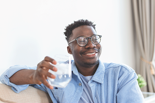 2021 Water Quality Report Cover -man drinking water and smiling