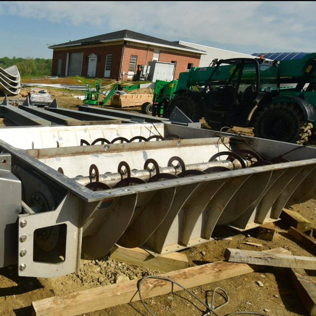 These auger units are part of the Cake Receiving Facility used to move the sludge.