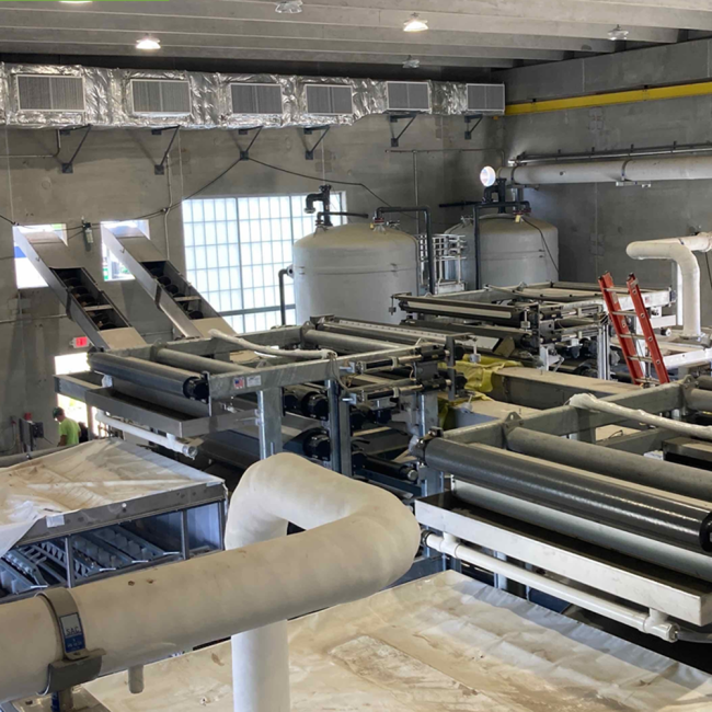 this photo shows the Belt Filter Presses and the Polymer Tanks that will be used in the dewatering process.  Along the top of the back wall is the odor ventilation system.