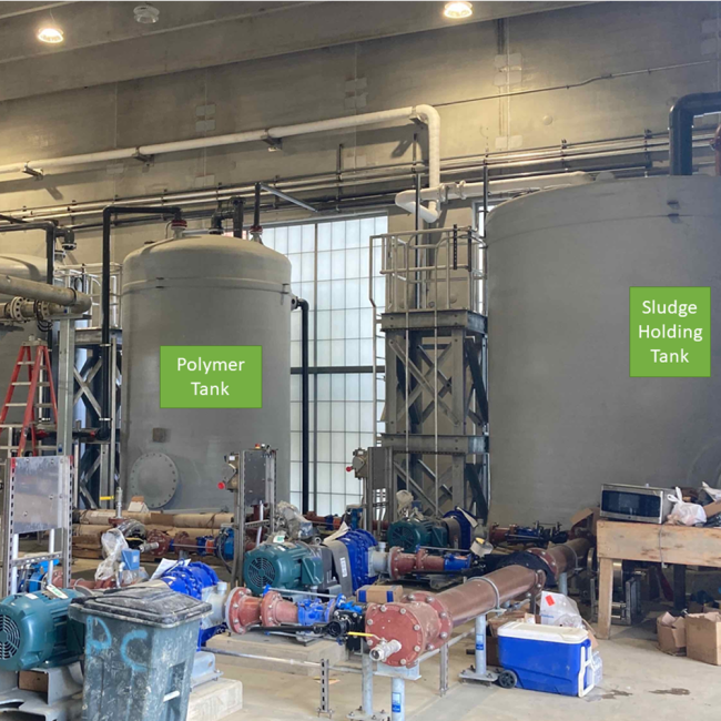 In the Solids Building this photo shows the Sludge Holding Tank, the Polymer Tanks and the associated process piping.