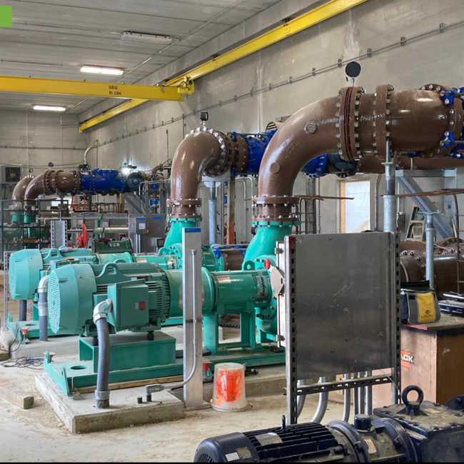 Inside the Digester Control Building you can see the green mixing pumps and motors.  The large process piping is all painted, bolted and supported in place.  At the top of the building near the ceiling is the yellow bridge crane that is now completed.