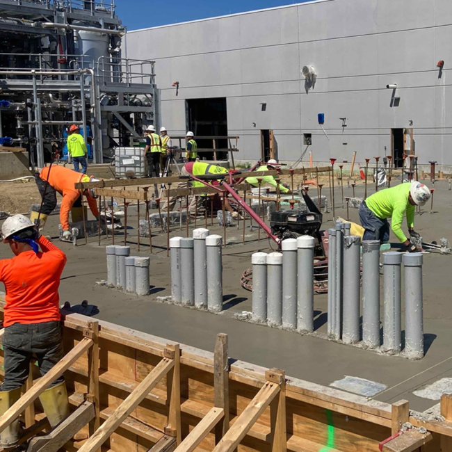 The concrete finishers doing their magic on the fresh slab pour.