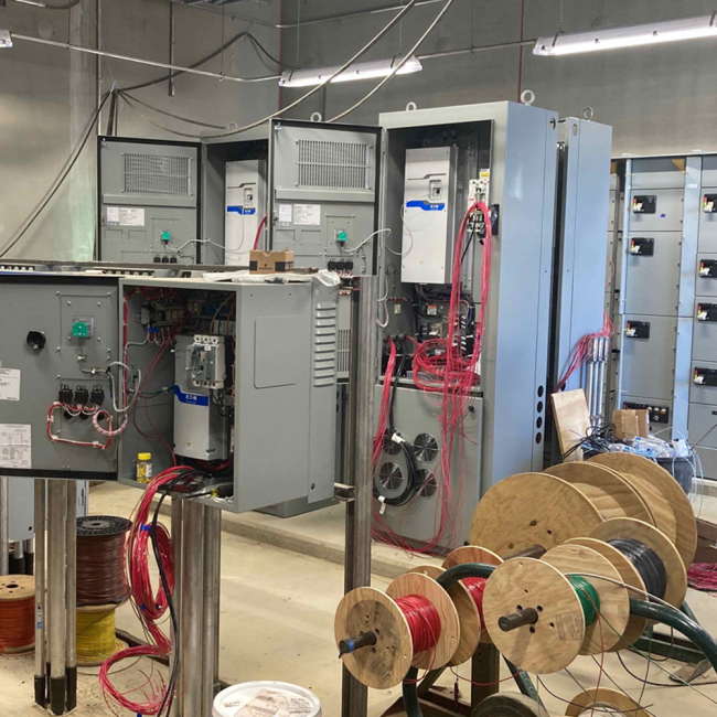 Inside the Electrical Room of the Digester Control Building, this equipment drives the pump motors that feed the Digesters.