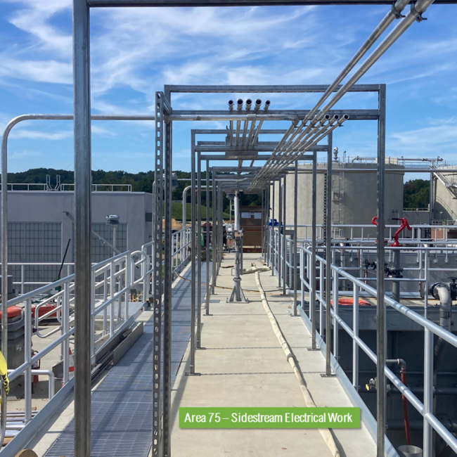 This photo is from the top deck of the reactors at the Sidestream Treatment Facility.  The small pipes overhead supported by the pipe racks are the electrical conduits.