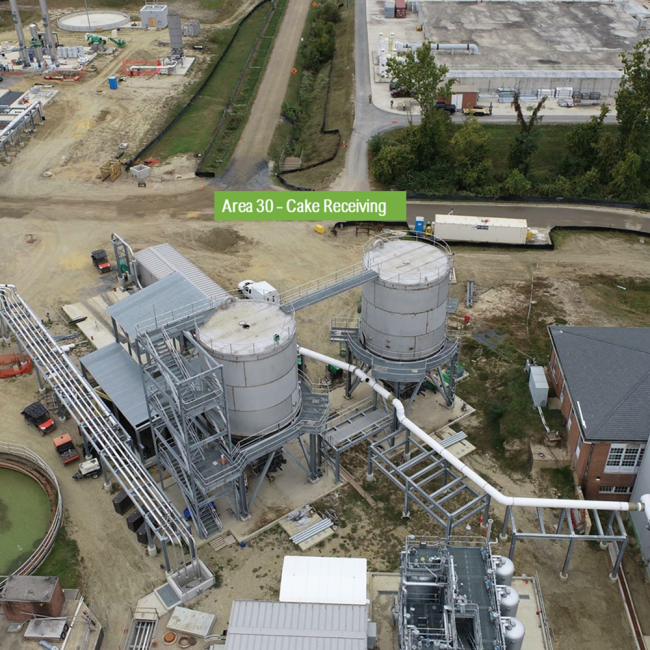 Aerial view of the Cake Receiving Facility.  The access bridge between the two silos is completed as is the majority of the piping.