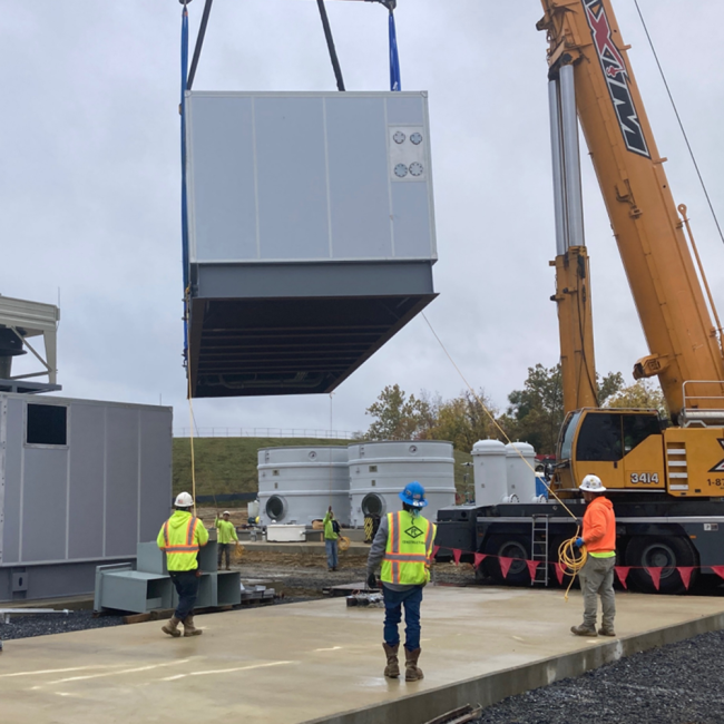 This is the second generator being set in place using the 5-ton crane on the right side of the photo.