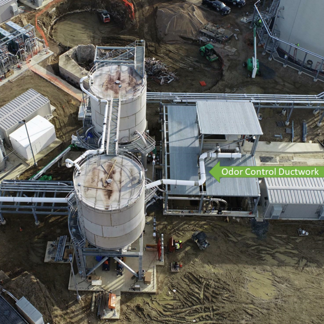 Large diameter white piping is the odor control ductwork at the cake receiving facility