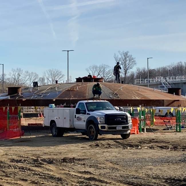 Welders are working on assembly of the Dome Cover for the Digested Sludge Storage Tank.