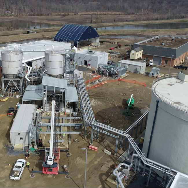 Aerial photo of the Cake Receiving Facility.  The crane is placing the structural beams for the framework that will prevent trucks from tipping over as they raise their truck bed.