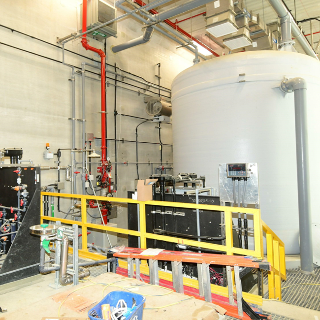 Contractor installing the Acid System at the Odor Control Building.