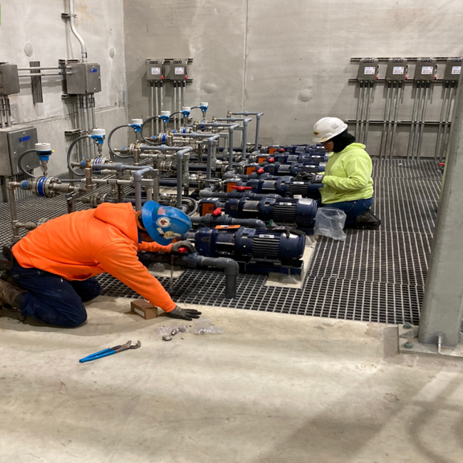 Inspecting the pumps in the Solids Building as they prepare for start-up.