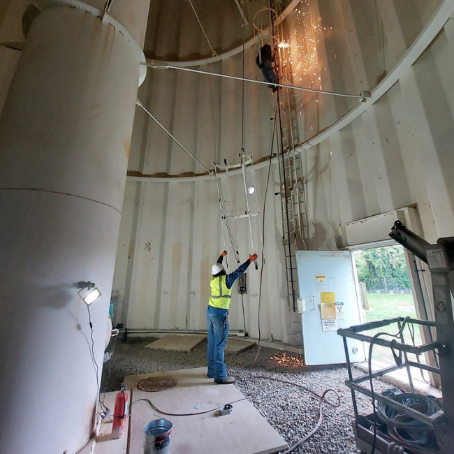 Removing ladder cage The existing ladder cage is being removed so that a new ladder can be installed that meets today’s current OSHA requirements.  