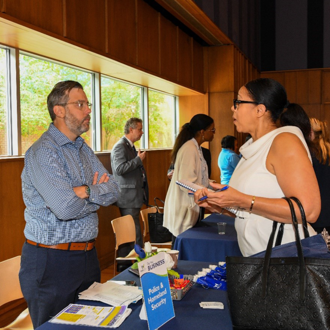 Police and Homeland Security Director David McDonough speaking with an attendee
