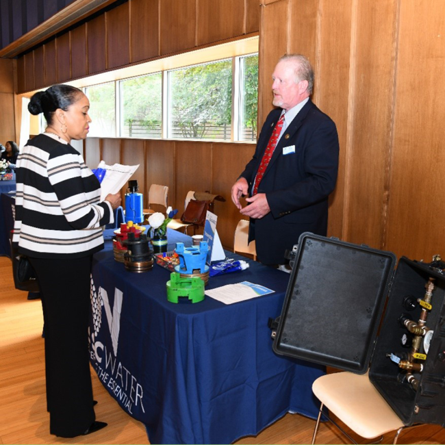 Office of Innovation and Research Director Keith Tyson speaking with an attendee