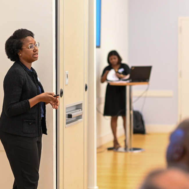 Caville Stanbury-Woolery, Division Manager discussing upcoming projects in a breakout session.