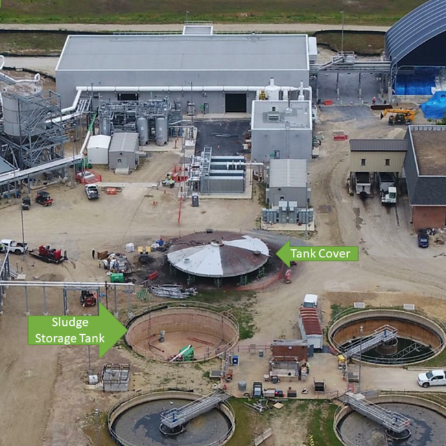 The coating is starting to go on the cover for the sludge storage tank. 