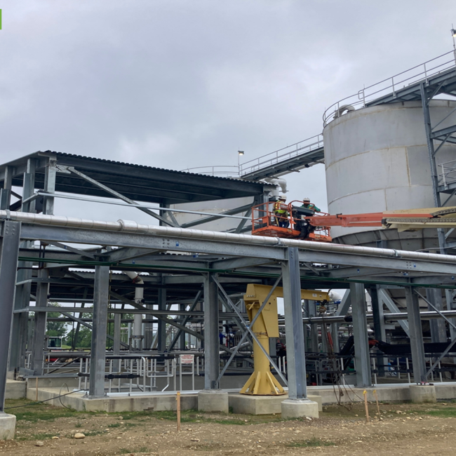 Contractor is installing metal panels on the sides of the Cake Receiving Facility.