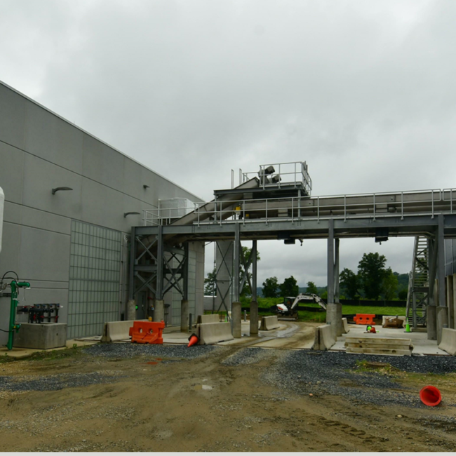 Paving under the truck load out chutes next to the Solids Building.