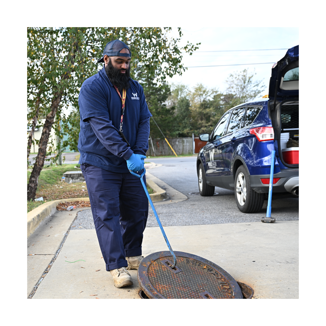 manhole opening by wssc water employee for FOG inspection