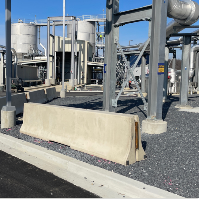 Concrete barriers placed along the truck approach to the Cake Receiving Facility.