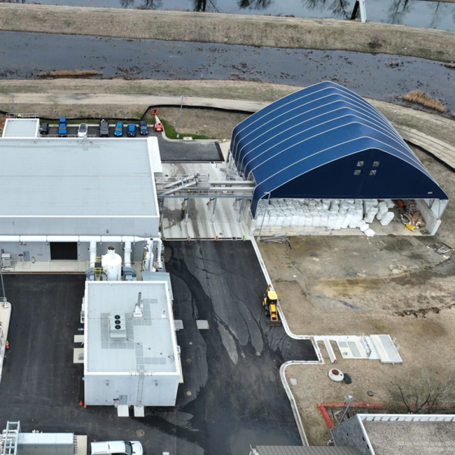 Under the blue canopy are the bags of filter media for the Sidestream Treatment Facility.