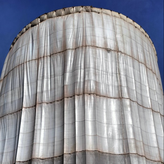 The containment raised around the tank; contains the abrasive blasting material and over spray from painting the tank.