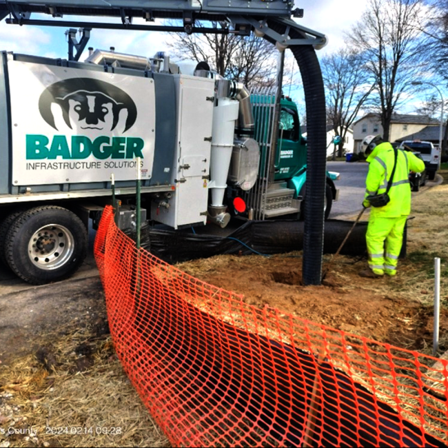 Completing a test pit with a vacuum truck to determine the location of the existing gas main to locate and confirm its depth.  A vac truck uses suction to remove soil and eliminates the risk of damaging existing utilities. 