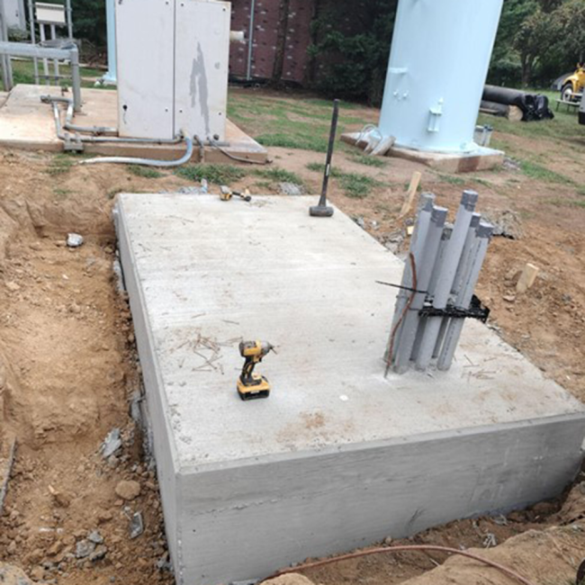 Generator Pad A concrete pad for the emergency generator has been built. If there’s a power outage, this generator will automatically turn on to keep the tank working properly.