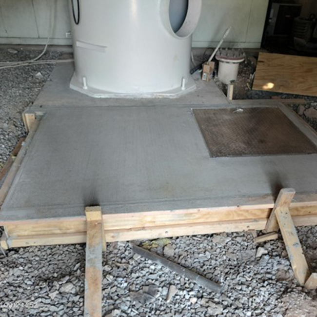 Access to Tank Pipes The top slab of the riser vault has a door for accessing the tank's inlet pipes.