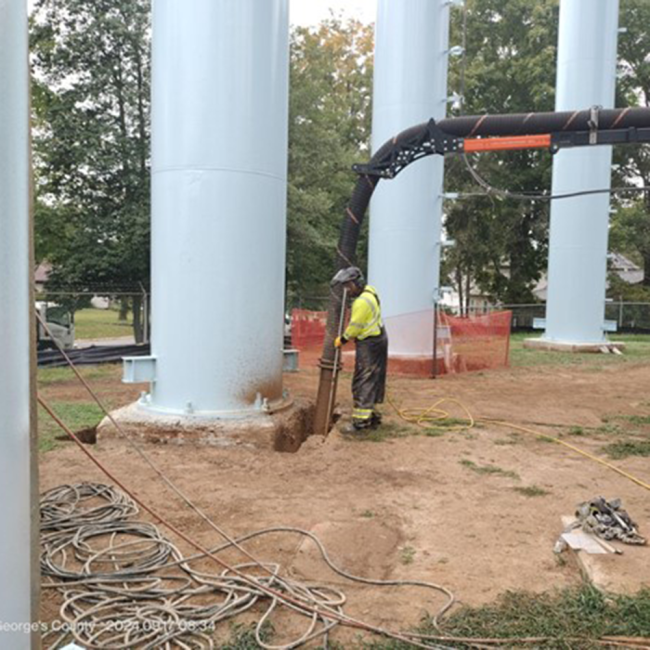Foundation Waterproofing Prep The soil around the tank’s foundation is vacuumed to clean and dry the area before applying waterproofing. This helps protect the foundation from water and keeps it durable.